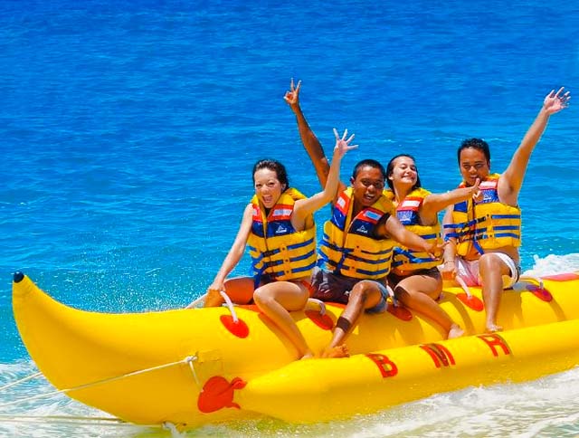 Group of tourists enjoying a thrilling banana boat ride in Goa.