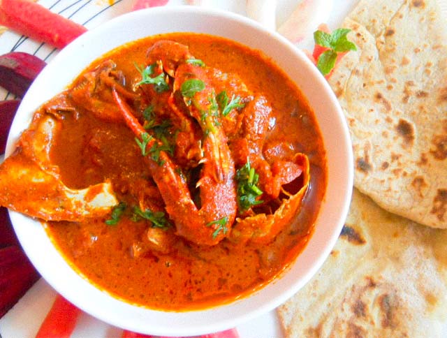 A bowl of fragrant Goan Crab Curry with spices, coconut milk, and fresh coriander.