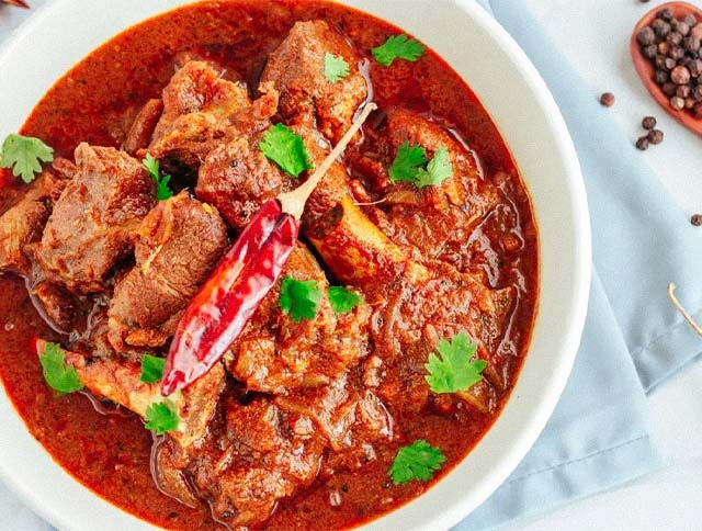 A plate of Pork Vindaloo with aromatic spices and tender chunks of pork.